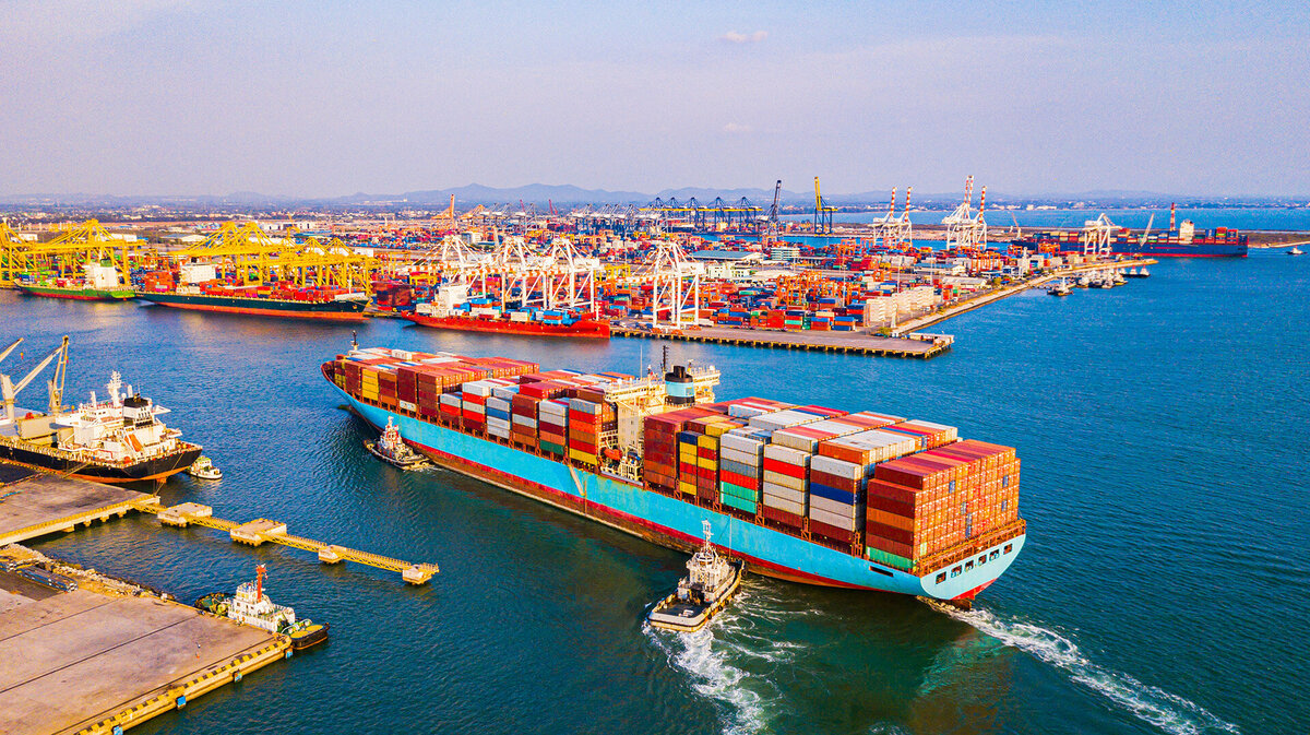 Cargo containers ship approaching cargo dock